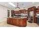 Island kitchen with granite countertops and wood cabinets at 16738 E Lone Mountain Rd, Scottsdale, AZ 85262