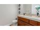 Clean bathroom with wood cabinets and updated fixtures at 16738 E Lone Mountain Rd, Scottsdale, AZ 85262