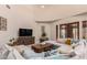 Spacious living room featuring a large sectional sofa and a wooden coffee table at 16738 E Lone Mountain Rd, Scottsdale, AZ 85262