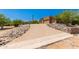 Paved driveway leads to a charming home nestled in a desert landscape at 16738 E Lone Mountain Rd, Scottsdale, AZ 85262