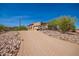 Brick driveway with a desert landscape leading to the home at 16738 E Lone Mountain Rd, Scottsdale, AZ 85262