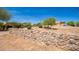 House with a rock wall and mature trees at 16738 E Lone Mountain Rd, Scottsdale, AZ 85262