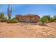 Tan stucco house with a tiled roof, and a gated patio area at 16738 E Lone Mountain Rd, Scottsdale, AZ 85262