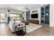 Modern living room with built-in shelving and large TV at 9649 E Solina Ave, Mesa, AZ 85212