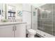 Modern bathroom with a walk-in shower, granite countertop, and white cabinets at 9649 E Solina Ave, Mesa, AZ 85212