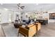 Open living room with hardwood floors and view into kitchen at 9649 E Solina Ave, Mesa, AZ 85212