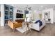 Open concept living room with built-in shelving and wood floors at 9649 E Solina Ave, Mesa, AZ 85212