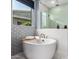 Relaxing bathroom with soaking tub and walk-in shower at 9649 E Solina Ave, Mesa, AZ 85212