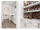 Built-in bar area with herringbone tile and shelving for glassware at 9649 E Solina Ave, Mesa, AZ 85212