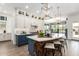 Modern kitchen with white and blue cabinets, a large island, and stainless steel appliances at 9649 E Solina Ave, Mesa, AZ 85212