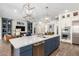 Modern kitchen island with white countertops, blue cabinets, and stainless steel appliances at 9649 E Solina Ave, Mesa, AZ 85212