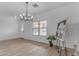 Spacious dining area with hardwood floors, chandelier, and large window at 3424 E Wyatt Way, Gilbert, AZ 85297