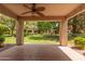 Covered patio with a ceiling fan, overlooking a lush green courtyard at 9140 W Kimberly Way, Peoria, AZ 85382