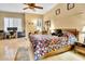 Bright main bedroom with large bed, home office space, and plantation shutters at 6529 W Via Montoya Dr, Glendale, AZ 85310