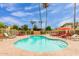 Community pool with lounge chairs and red umbrellas at 4610 N 68Th St # 478, Scottsdale, AZ 85251