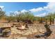 Relaxing fire pit area with stone patio and seating at 226 W Lazy K Ranch Rd, New River, AZ 85087