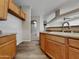 Kitchen with wood cabinets, white appliances and laminate flooring at 6607 S 5Th Pl, Phoenix, AZ 85042