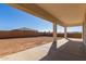 Covered patio extends from the house, overlooking a large backyard at 23997 N 172Nd Ave, Surprise, AZ 85387