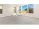 Bright bedroom with grey carpet and large windows at 23997 N 172Nd Ave, Surprise, AZ 85387