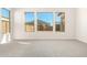 Well-lit bedroom featuring grey carpet and expansive windows at 23997 N 172Nd Ave, Surprise, AZ 85387