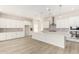 Modern kitchen with white cabinets, quartz countertops, and island at 23997 N 172Nd Ave, Surprise, AZ 85387