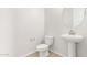Modern powder room with pedestal sink and updated fixtures at 23997 N 172Nd Ave, Surprise, AZ 85387