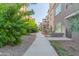 Paved walkway winds through a well-landscaped community with mature trees and shrubs at 5350 E Deer Valley Dr # 4271, Phoenix, AZ 85054