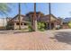 Attractive exterior of a multi-story building with palm trees and a brick driveway at 5350 E Deer Valley Dr # 4271, Phoenix, AZ 85054