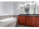 Bathroom with a soaking tub and double sinks at 5350 E Deer Valley Dr # 4271, Phoenix, AZ 85054