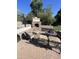 Inviting outdoor patio with a stone fireplace, fire pit, and comfortable seating at 7264 W Cielo Grande --, Peoria, AZ 85383