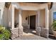 Elegant entryway with columns, stonework, and a dark wooden door at 15027 N 28Th St, Phoenix, AZ 85032