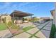 Covered patio with seating area, built-in BBQ, and fire pit at 19650 E Jeanna Ct, Queen Creek, AZ 85142