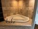 Corner jacuzzi bathtub with tile surround at 5136 N 31St Pl # 626, Phoenix, AZ 85016