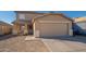 Two-story house with tan exterior, two-car garage, and small front yard at 12902 N 127Th Ave, El Mirage, AZ 85335