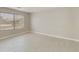 Well-lit bedroom featuring tile flooring and a large window at 8762 E Posada Ave, Mesa, AZ 85212