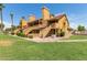 Attractive stucco condo building with grassy landscaping and palm trees at 4901 S Calle Los Cerros Dr # 267, Tempe, AZ 85282