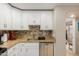 White kitchen cabinets, granite counters, and stainless steel appliances at 4901 S Calle Los Cerros Dr # 267, Tempe, AZ 85282