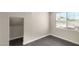 Simple bedroom with dark brown laminate floors and a window at 819 S 3Rd Ave, Phoenix, AZ 85003