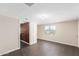 Simple bedroom with dark brown laminate floors and a window at 819 S 3Rd Ave, Phoenix, AZ 85003