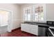 Kitchen with white cabinets, dark countertop and red tile floor at 819 S 3Rd Ave, Phoenix, AZ 85003