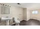 Simple bathroom with pedestal sink, toilet, and laminate floor at 819 S 3Rd Ave, Phoenix, AZ 85003
