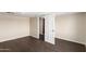 Simple bedroom with dark wood floors and an open door at 819 S 3Rd Ave, Phoenix, AZ 85003