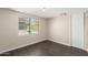 Simple bedroom with dark brown laminate floors and a window at 819 S 3Rd Ave, Phoenix, AZ 85003