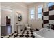 Stylish bathroom with black and white checkered floor and clawfoot tub at 819 S 3Rd Ave, Phoenix, AZ 85003