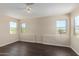Bright bedroom with dark brown laminate floors and two windows at 819 S 3Rd Ave, Phoenix, AZ 85003
