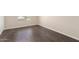 Simple bedroom with dark brown laminate floors and a window at 819 S 3Rd Ave, Phoenix, AZ 85003