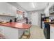 View of kitchen with white cabinets, red countertops, and appliances at 140 W University Dr, Mesa, AZ 85201