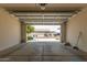 Spacious garage with open door, view of the street and driveway at 11227 W Bloch Rd, Tolleson, AZ 85353