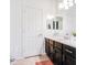 Bathroom with dark vanity and large mirror at 772 N Swan Dr, Gilbert, AZ 85234