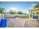 Landscaped backyard with brick pavers, fire pit, and covered patio at 772 N Swan Dr, Gilbert, AZ 85234